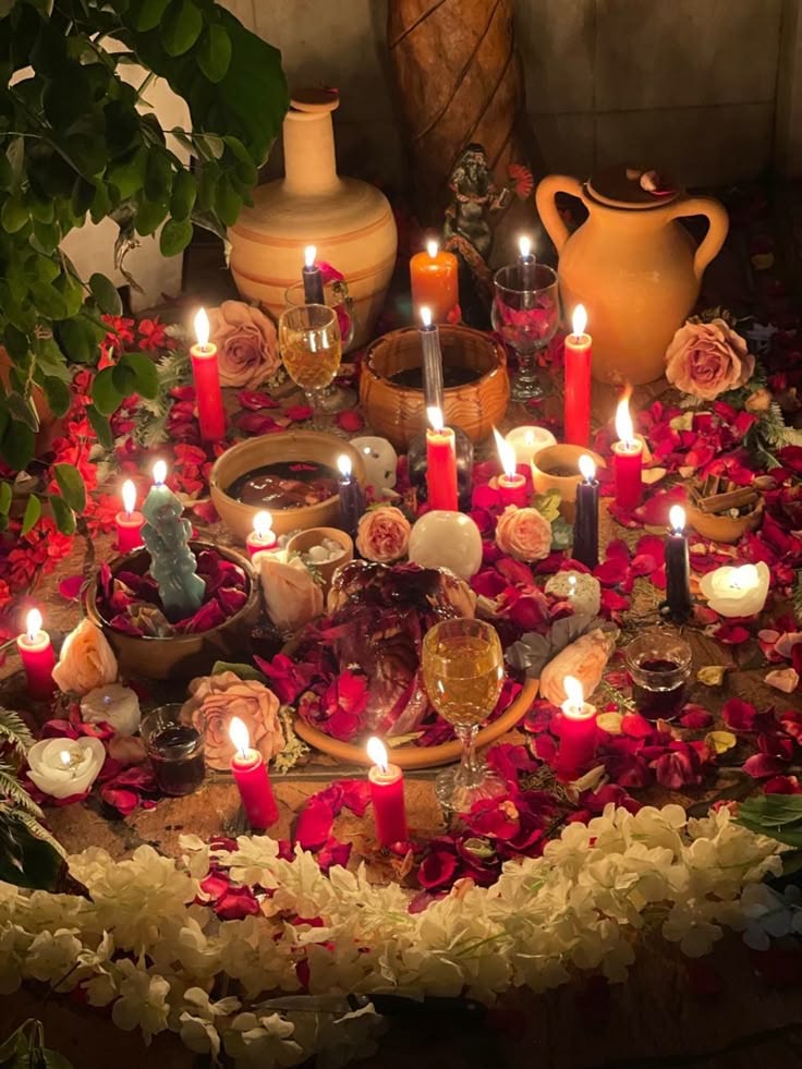 Mesa espiritual preparada com velas, flores e elementos ritualísticos